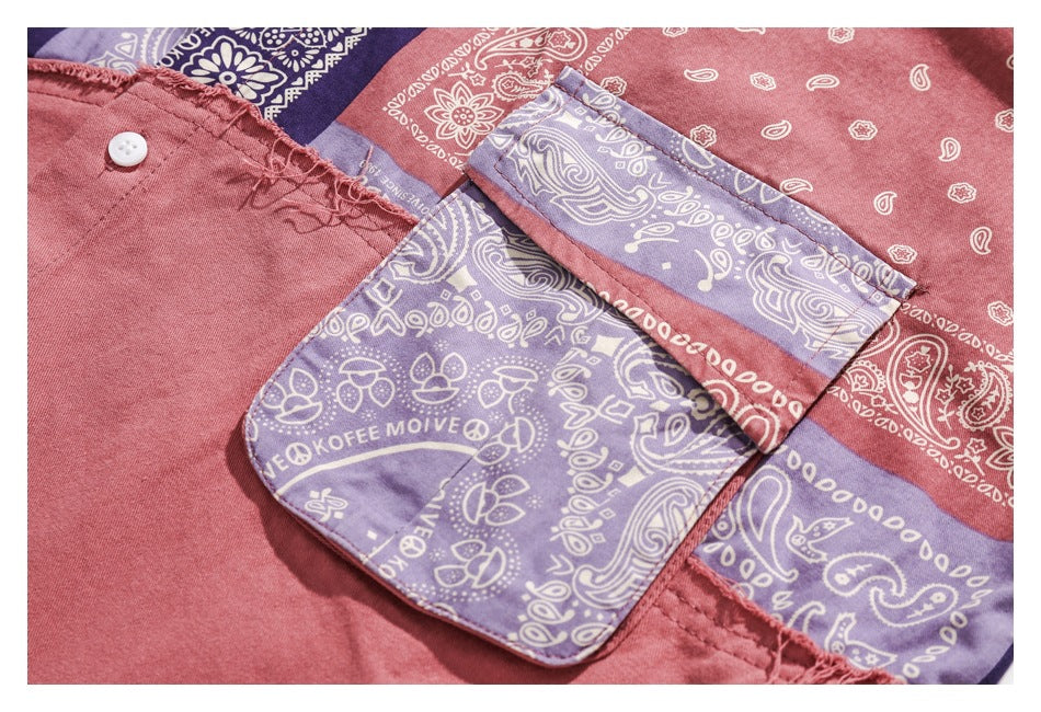 Close-up of a large lavender bandana-print pocket and matching patchwork on the pink shirt.