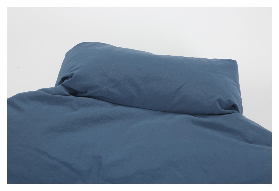 Close-up of a dark blue padded garment lining and matching fabric against a white background.