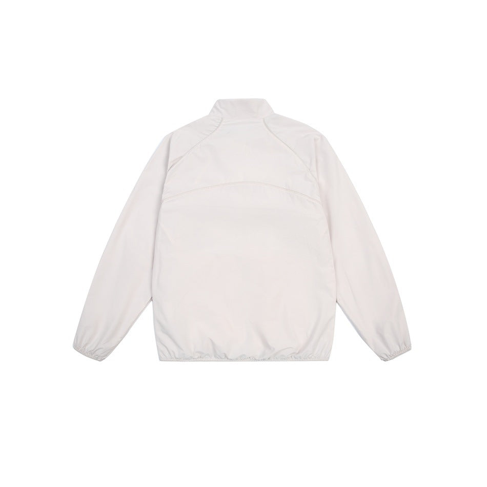 Back view of an off-white long-sleeve jacket with a stand collar, curved seams and elastic cuffs and hem.