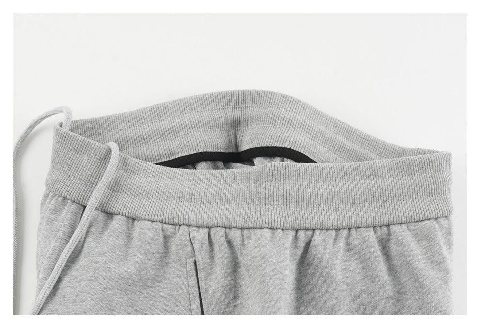 Close-up of the light gray sweatpants waistband opened to show its inner edge and drawstring.