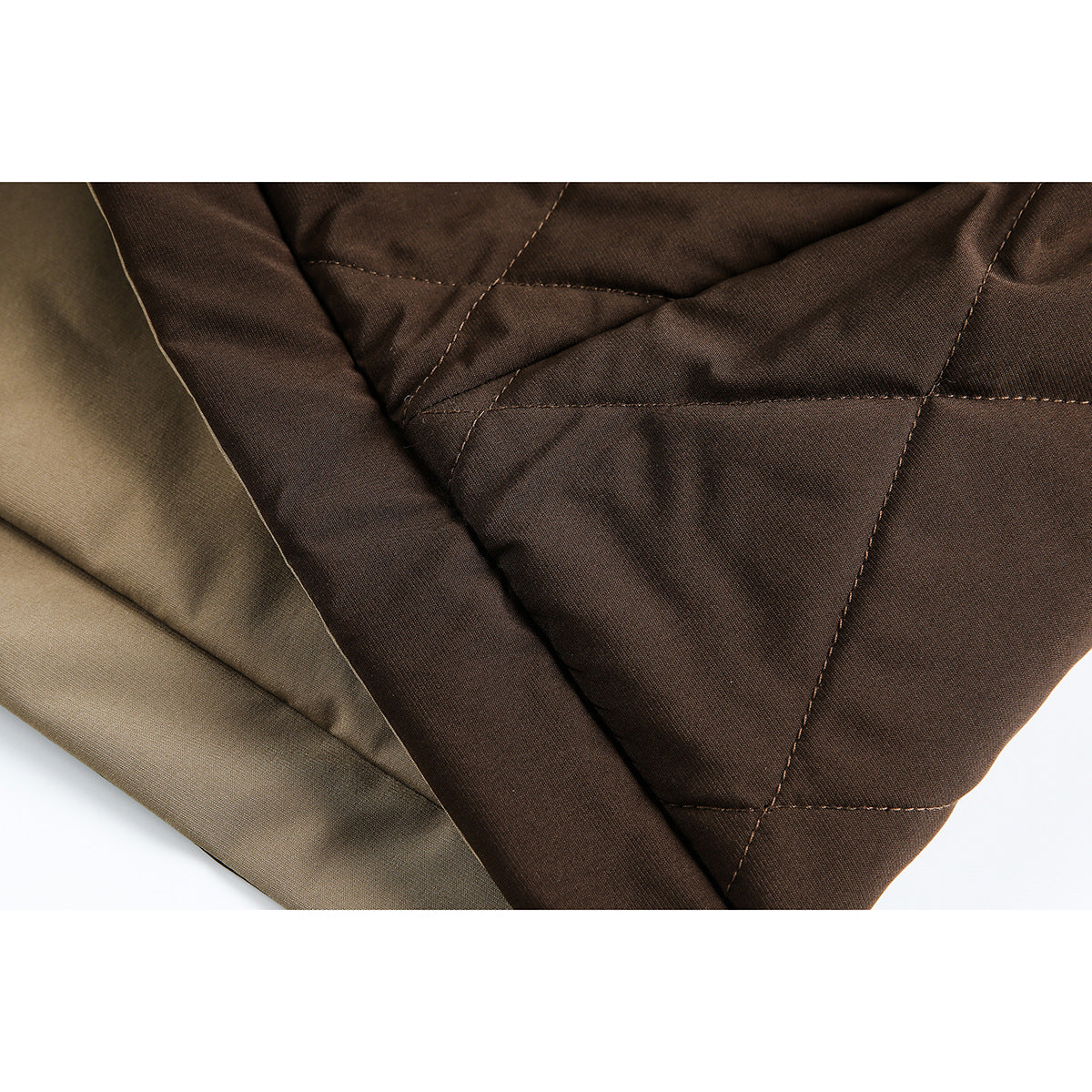 Close-up of dark brown diamond quilting beside the jacket's beige lining.