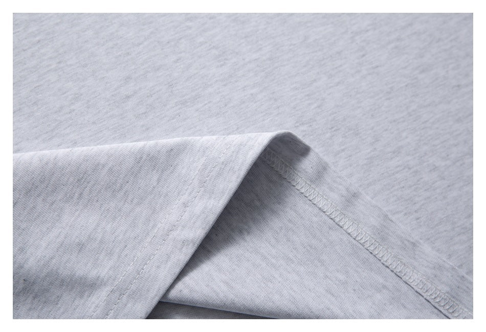 Folded light gray garment edge showing the inside overlock stitching.
