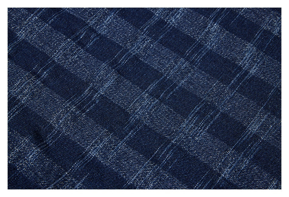 Close-up of dark navy fabric with a subtle diagonal woven pattern.