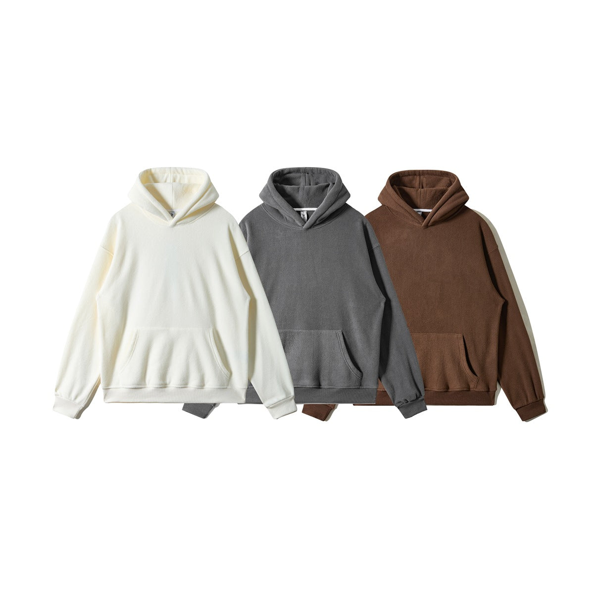 Three plain pullover hoodies with kangaroo pockets shown in cream, charcoal gray, and brown.