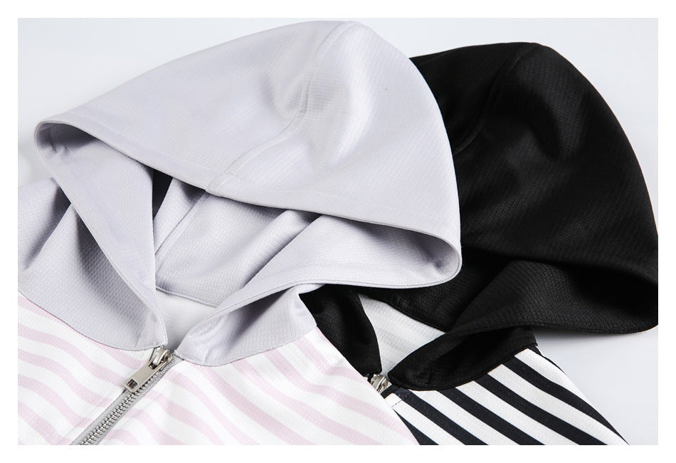 Close-up of light gray and black hoodie hoods and zip closures, with pink-and-white and black-and-white striped fabric.