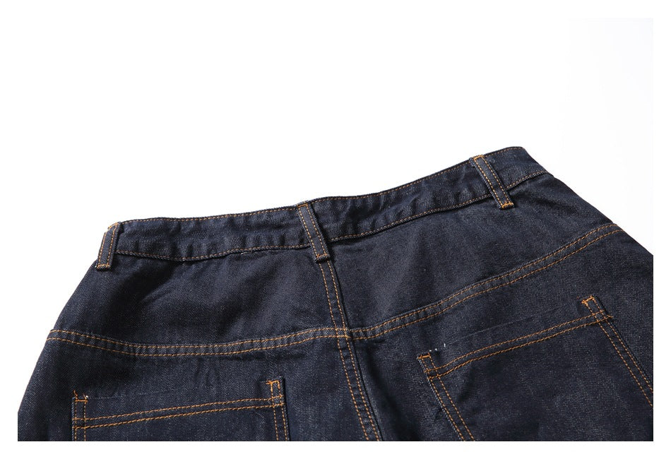 Upper back view of dark indigo jeans with belt loops, a yoke seam, and two pockets.
