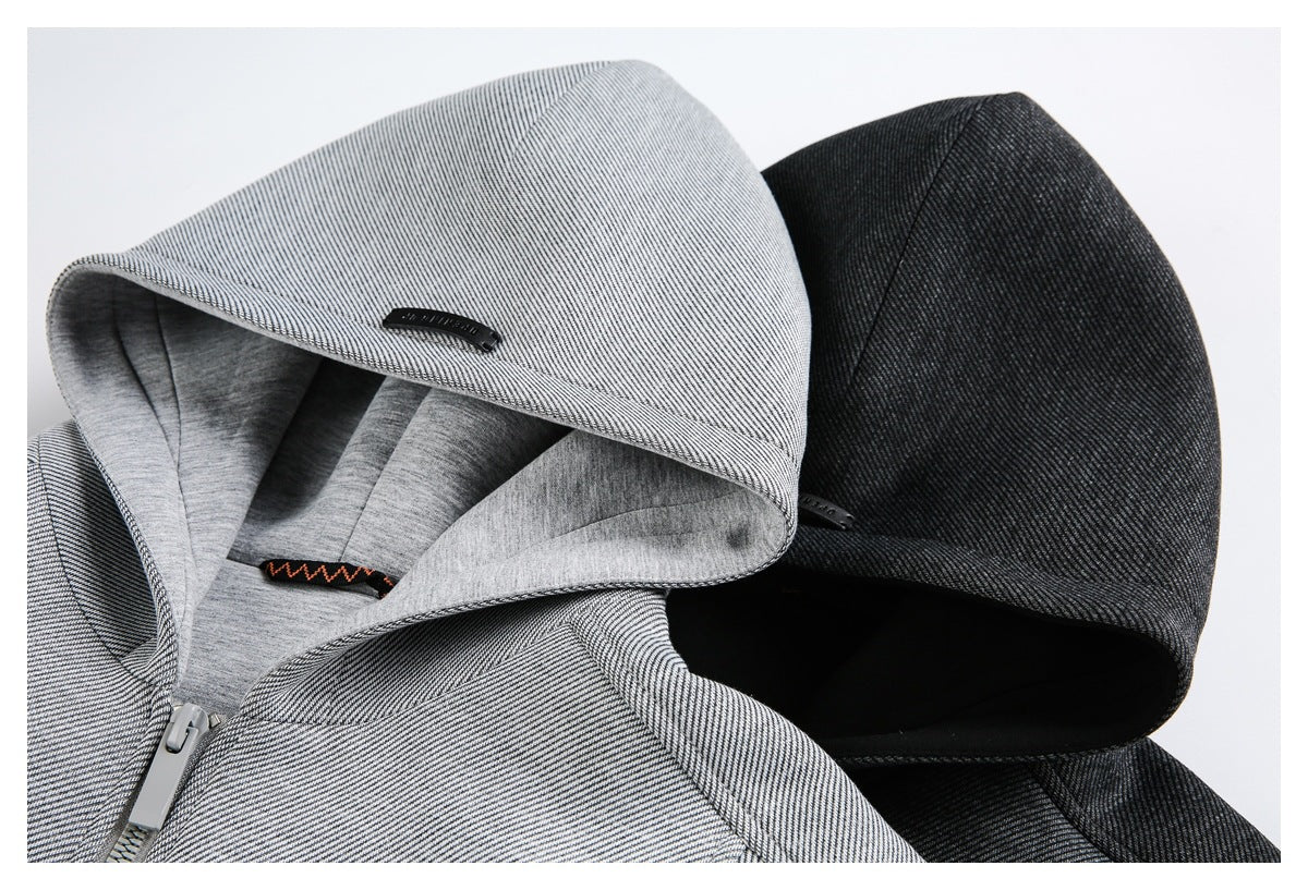 Close-up of light gray and charcoal hooded jackets, showing the hoods, striped outer fabric, and gray lining.