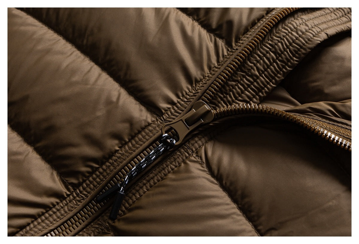 Close-up of the brown puffer jacket's chunky front zipper and stitching.