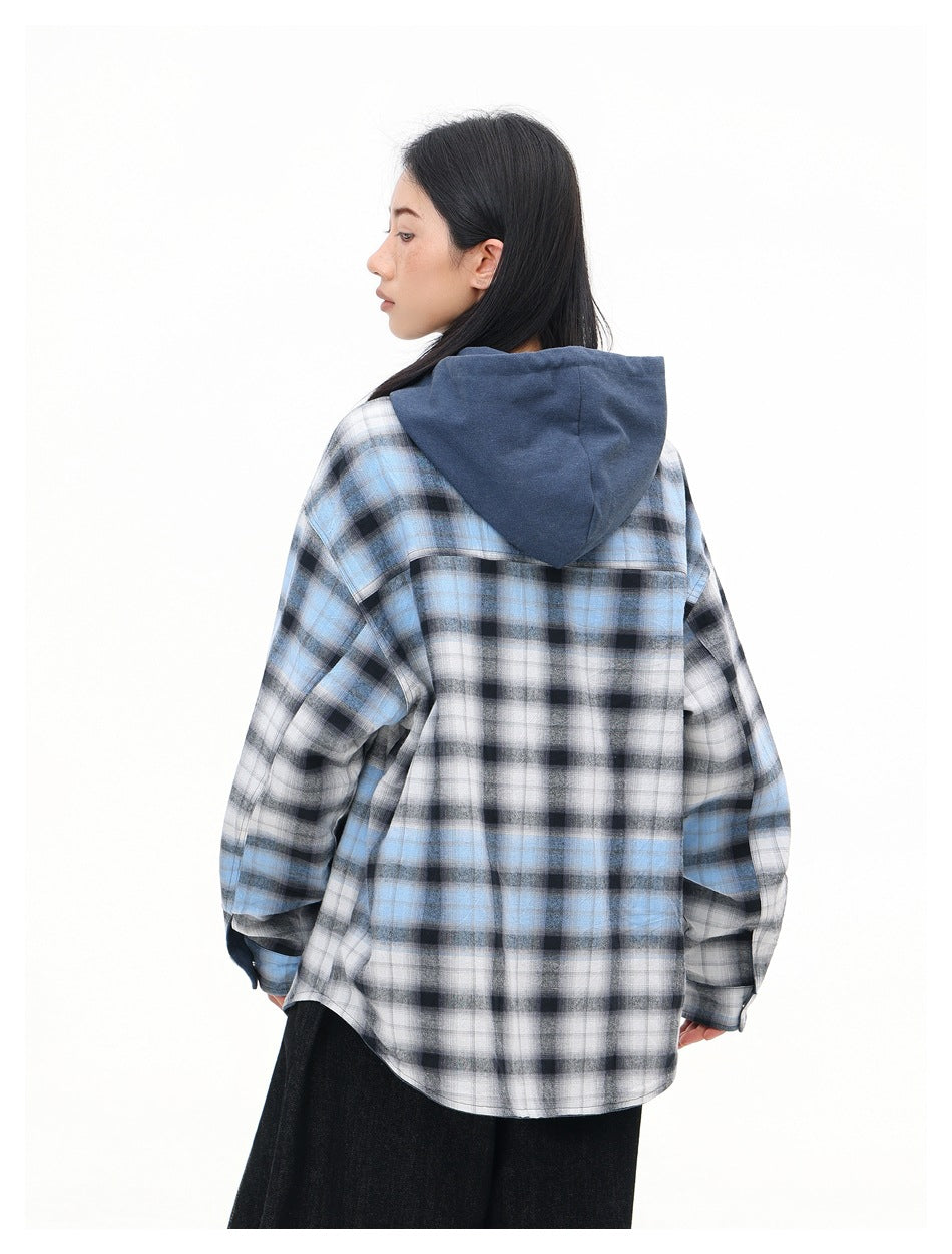 Back view of a model wearing a blue, black, and white plaid shirt with a solid blue hood.