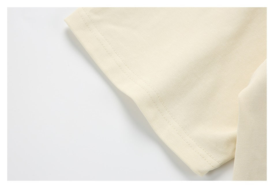 Close-up of a cream sleeve edge and double-row stitching.