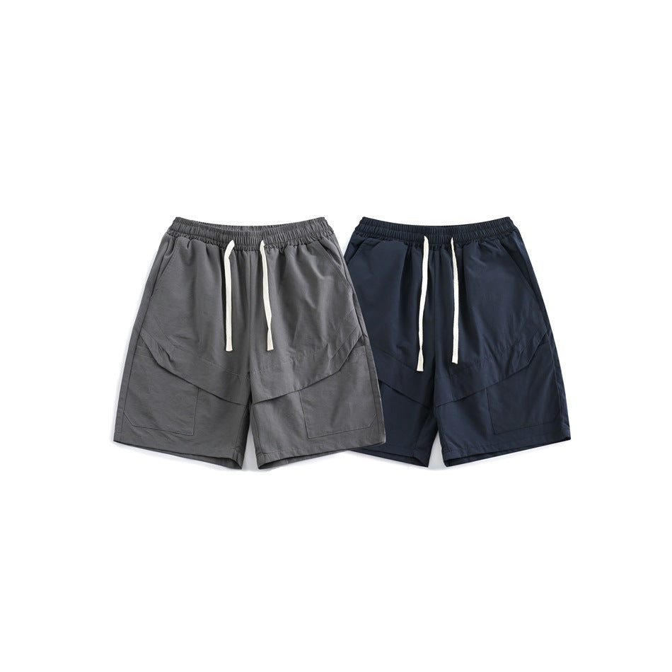 Gray and navy shorts shown from the front, with elastic waistbands, white drawstrings, and large patch pockets.