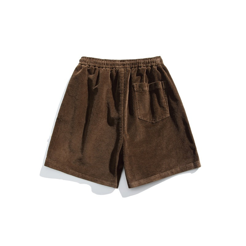 Brown corduroy shorts shown from the back, with an elastic waistband and one patch pocket.