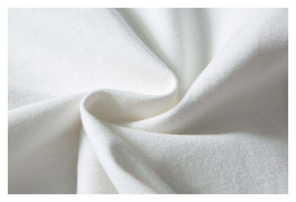 Close-up of softly draped white fabric showing its surface texture.