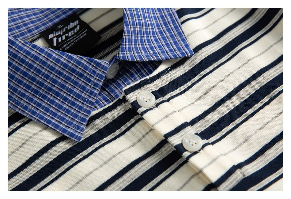 Close-up of a blue plaid collar beside the cream shirt's navy and gray striped button placket.