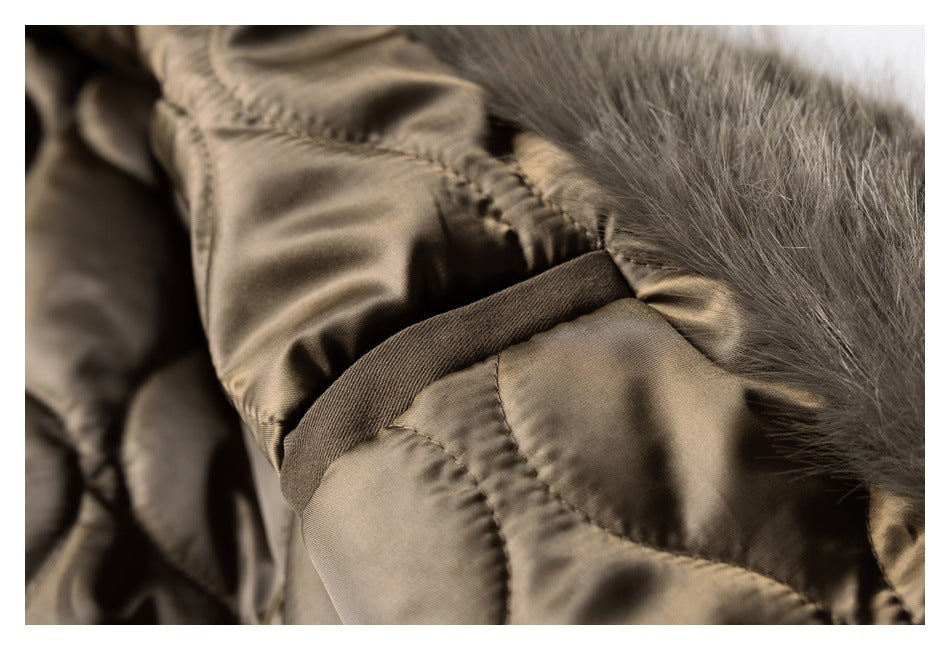 Close-up of the coat's shiny quilted lining, seams, and gray-brown fur trim.