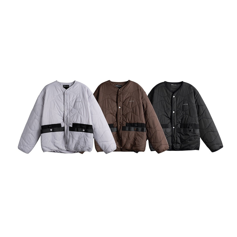 Three front views of a quilted snap-front jacket in light gray, brown and black, each with a black waist strap.