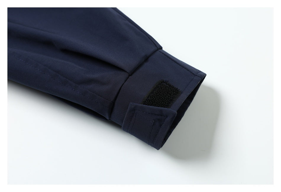 Close-up of a dark navy sleeve cuff with a black hook-and-loop closure.