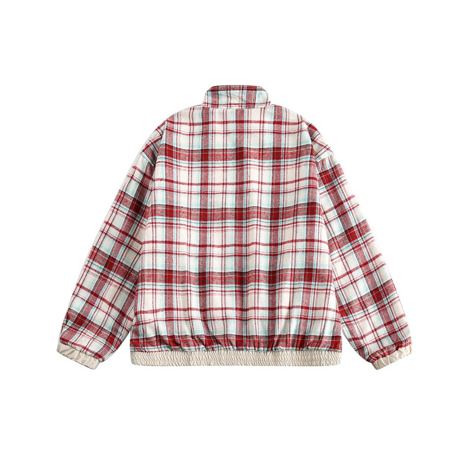 Back view of a white jacket with red, teal, and gray plaid, a stand collar, and elasticated cuffs and hem.