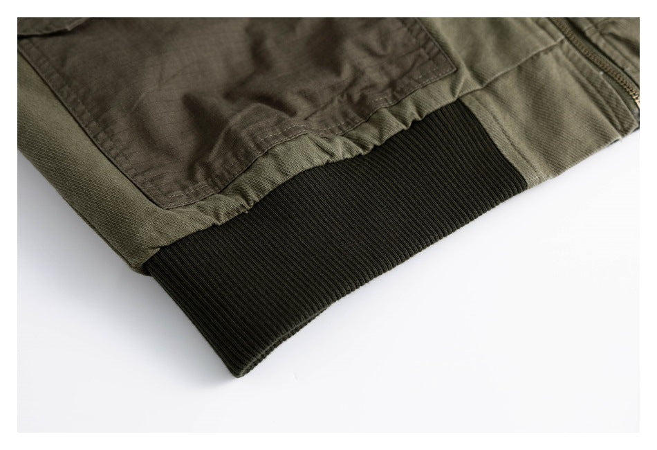 Close-up of an olive jacket pocket above a wide dark ribbed hem.
