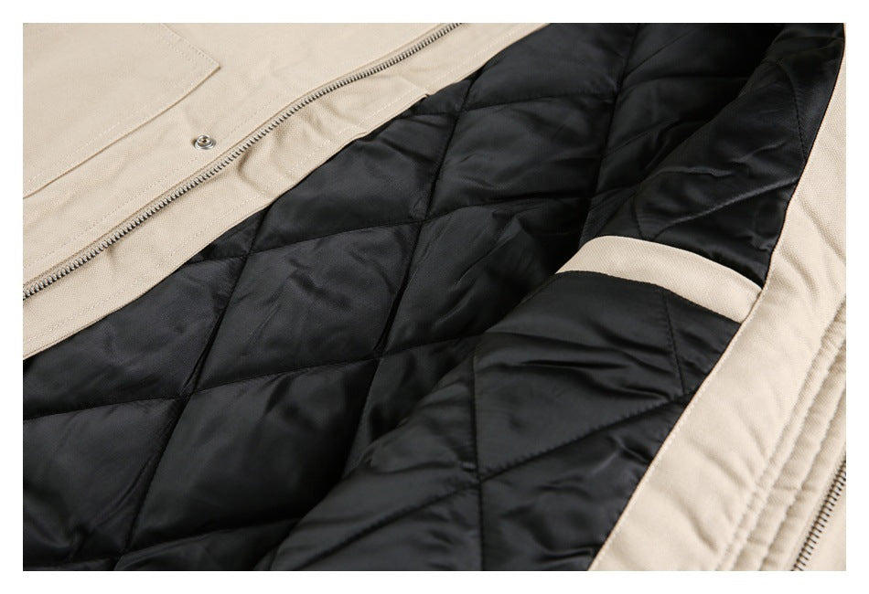 Open beige coat showing black diamond-quilted lining, zipper, and snap fastener.