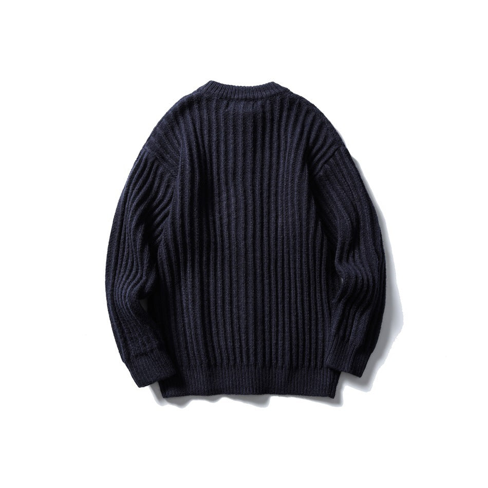 Back view of a dark navy ribbed cardigan with long sleeves and a ribbed hem.