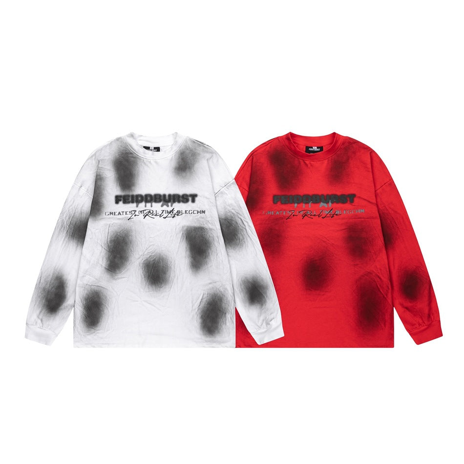 Two long-sleeve graphic shirts shown side by side: white with gray-black tie-dye and red with dark tie-dye.