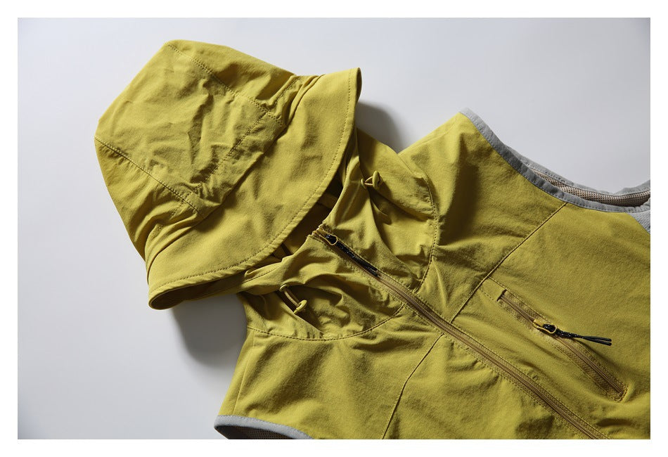 Mustard yellow hooded sleeveless vest laid flat, with a front zipper, zip pockets, and gray mesh trim.