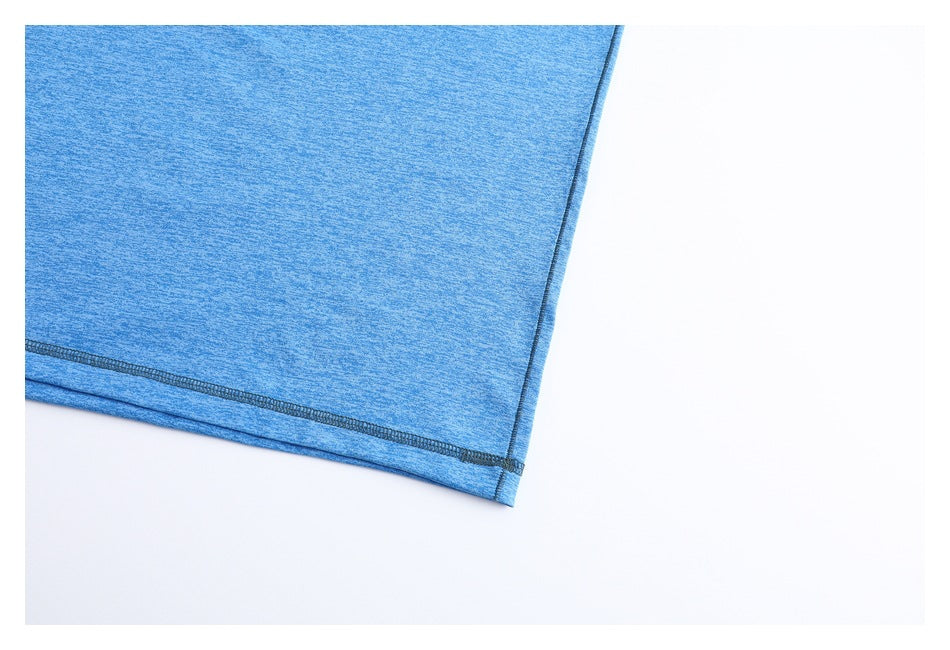 Close-up of blue heathered garment fabric with a dark stitched hem and side seam.