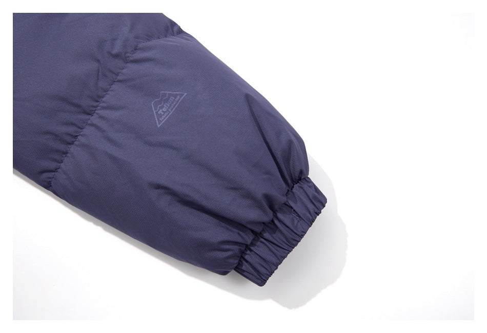 Close-up of a dark blue sleeve with an elastic cuff and a small triangular logo.