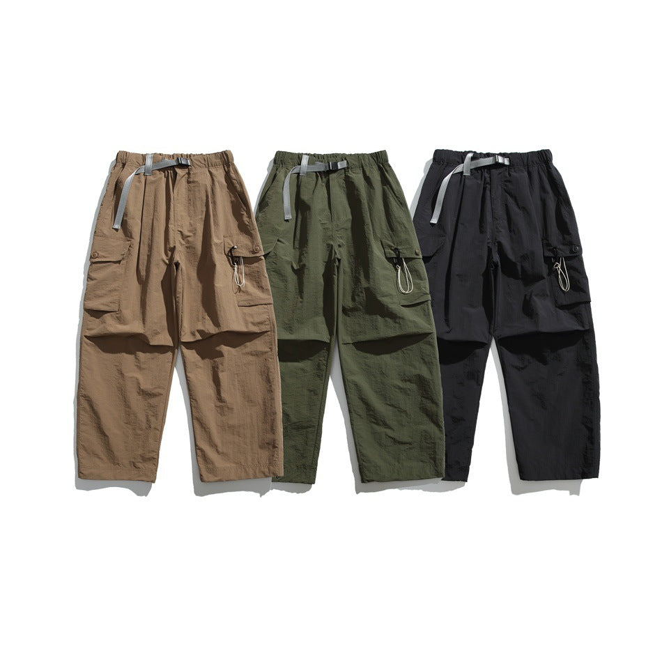 Three pairs of cargo trousers shown from the front in tan, olive green, and black, with gray belts and side pockets.