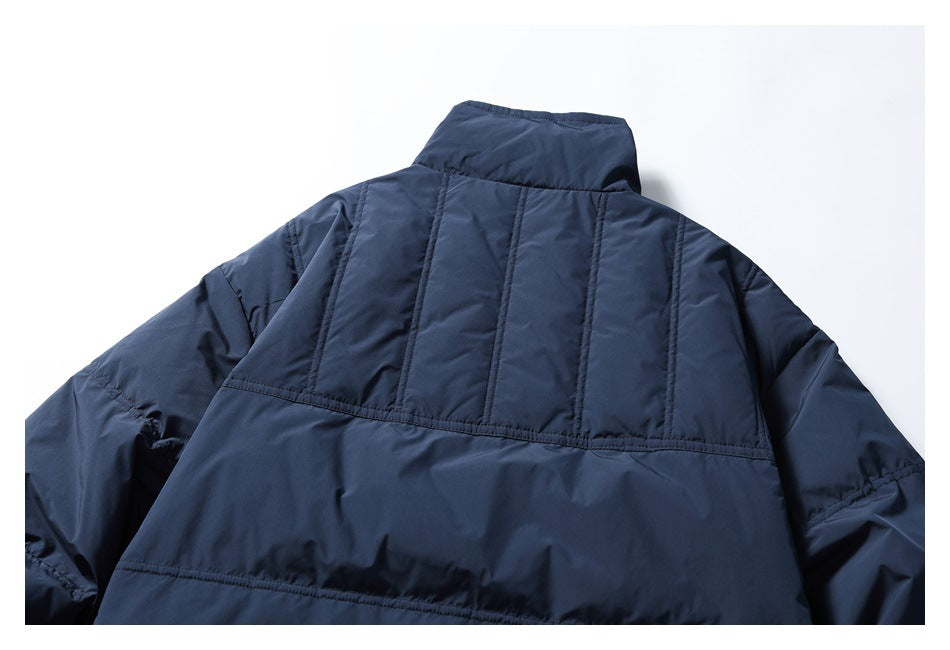 Close-up of the jacket's rear high collar and vertically stitched upper back panels.