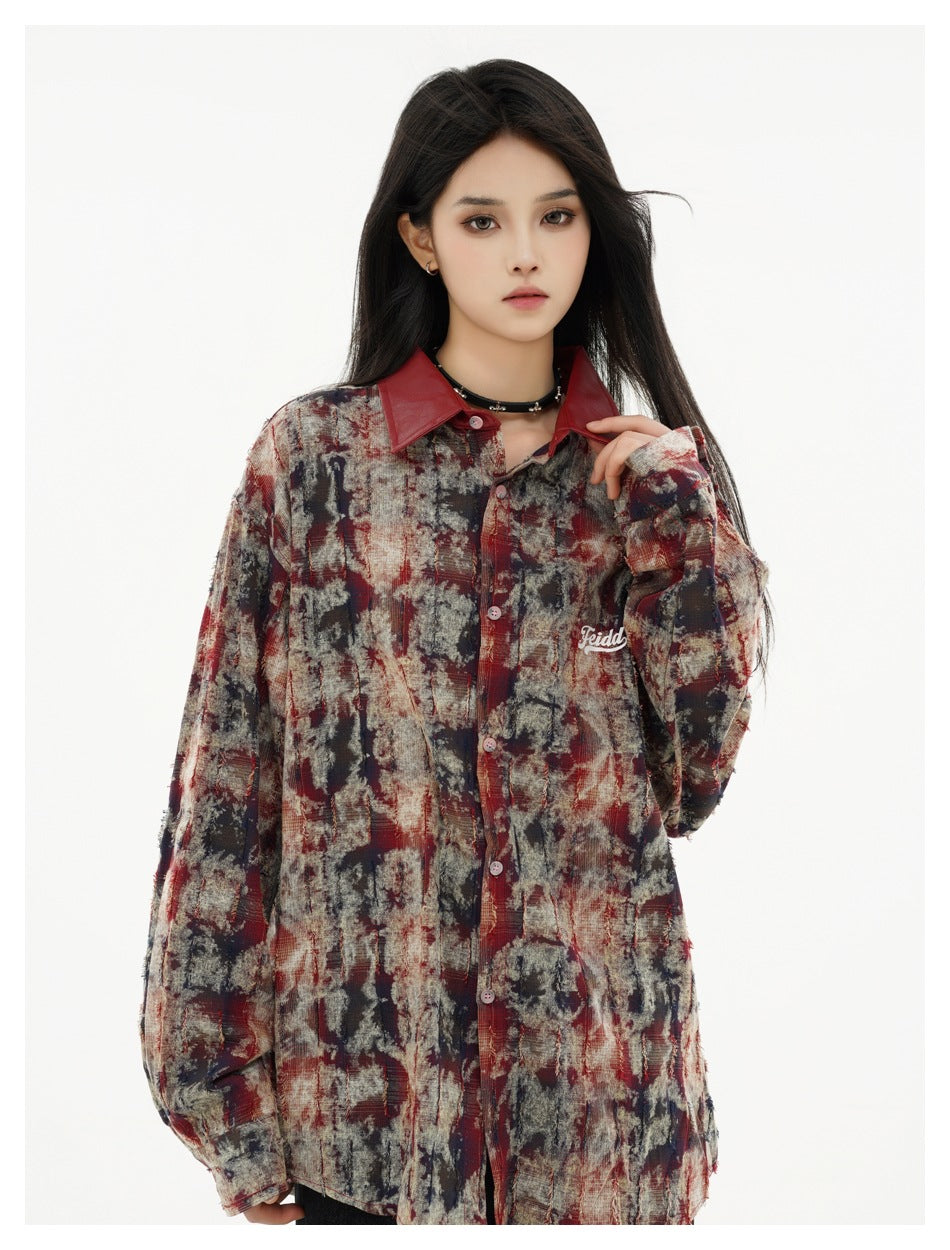 Model wearing an oversized abstract-print shirt in burgundy, charcoal, and beige with a dark red collar.
