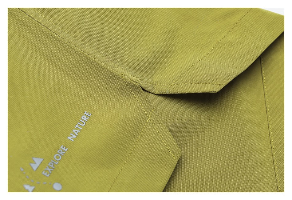 Close-up of yellow-green garment panels and stitched seams with part of the white “Explore Nature” print.