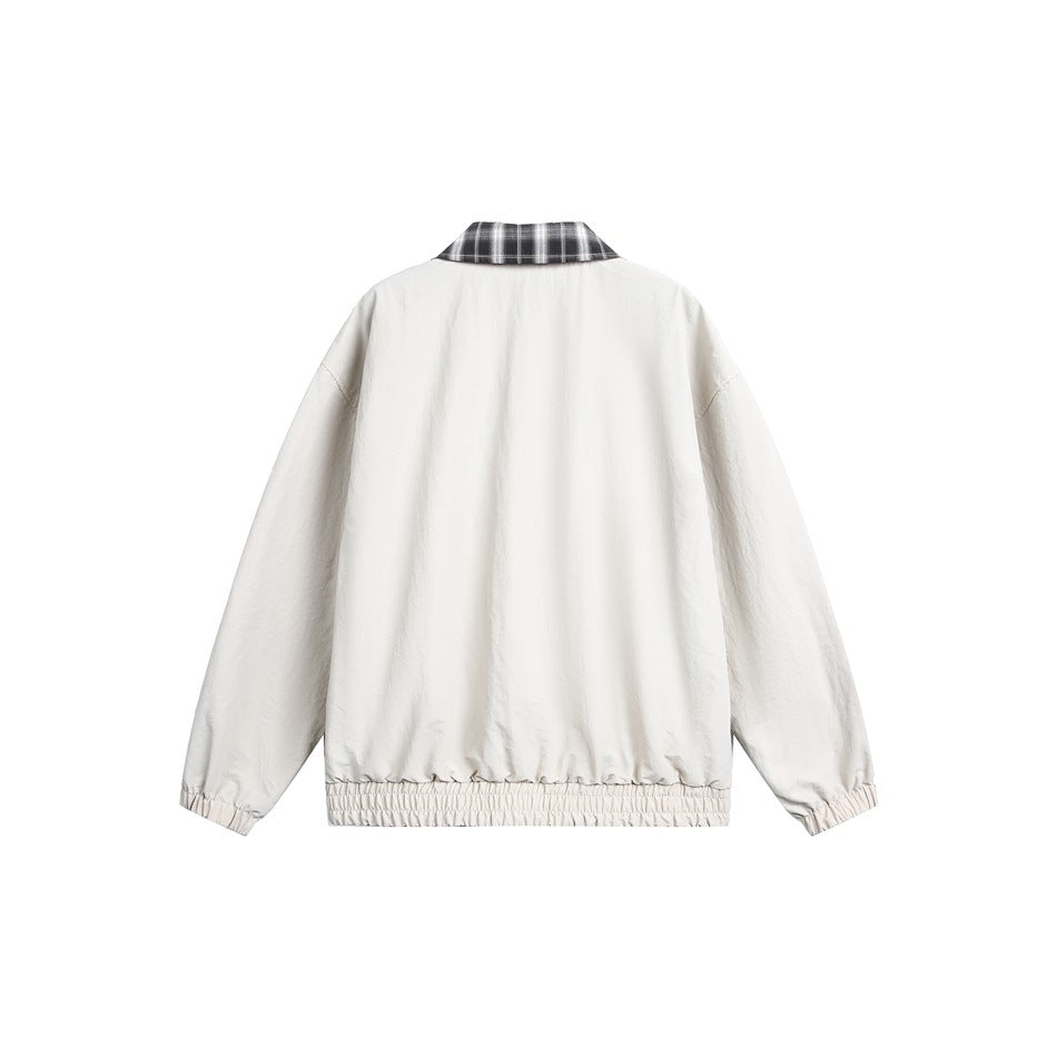 Back view of a cream jacket with a black-and-white plaid collar and gathered cuffs and hem.