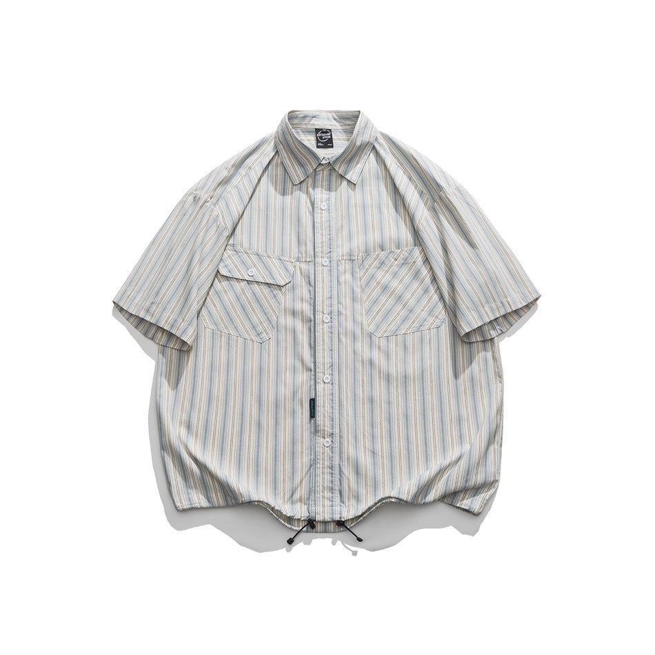 Front of a light blue and beige striped short-sleeve shirt with chest pockets and a drawstring hem