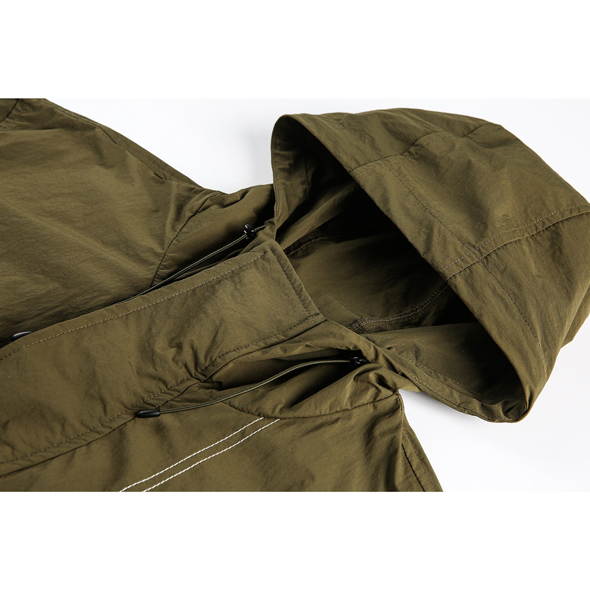 Close-up of an olive hooded jacket showing the hood, drawcords, and contrasting seam stitching.