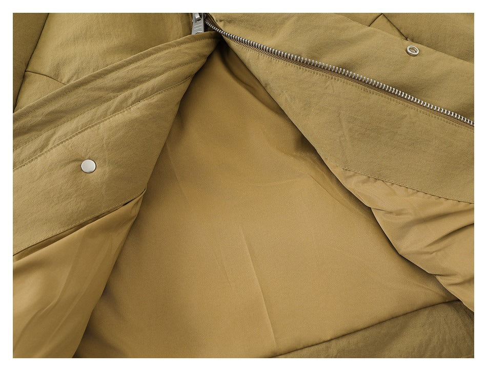Close-up of a tan jacket opened to show its lining, zipper, and snap fasteners.