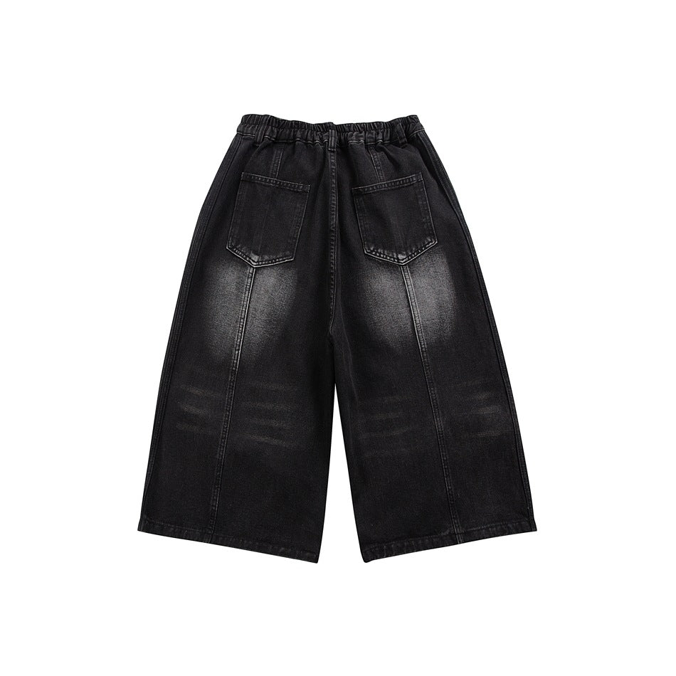 Black faded denim wide-leg shorts, back flat lay, with two patch pockets, elastic waistband and vertical seams