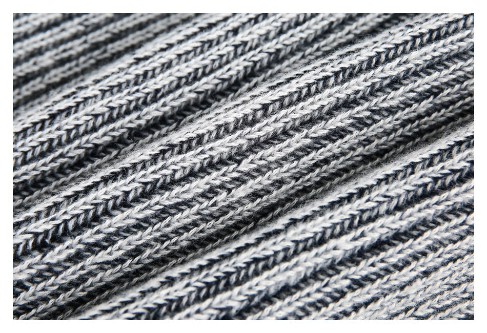 Macro view of the black and white marled knit yarn and raised ribbed texture.