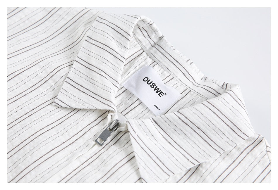 Close-up of the striped shirt's wide collar, front zipper and sewn-in neck label.