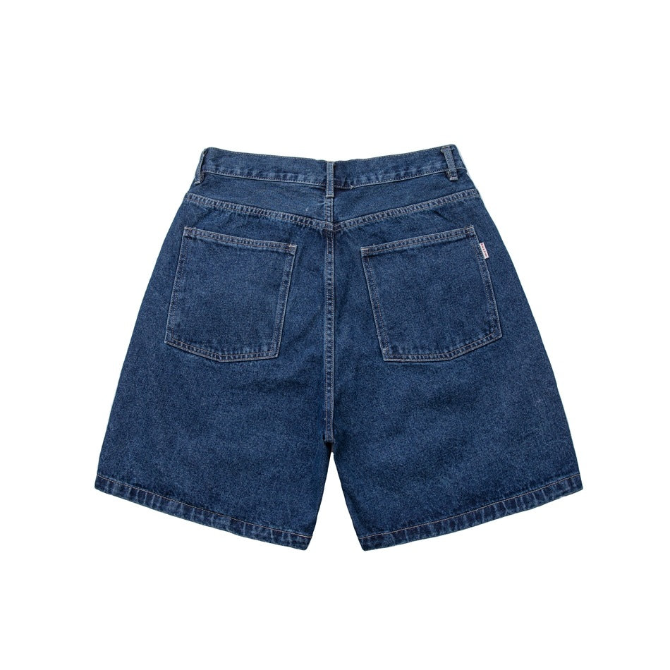 Back of blue washed denim shorts showing two patch pockets, belt loops and contrast stitching on a white background