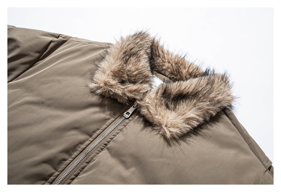 Close-up of a taupe jacket's plush brown faux-fur collar and silver front zipper.