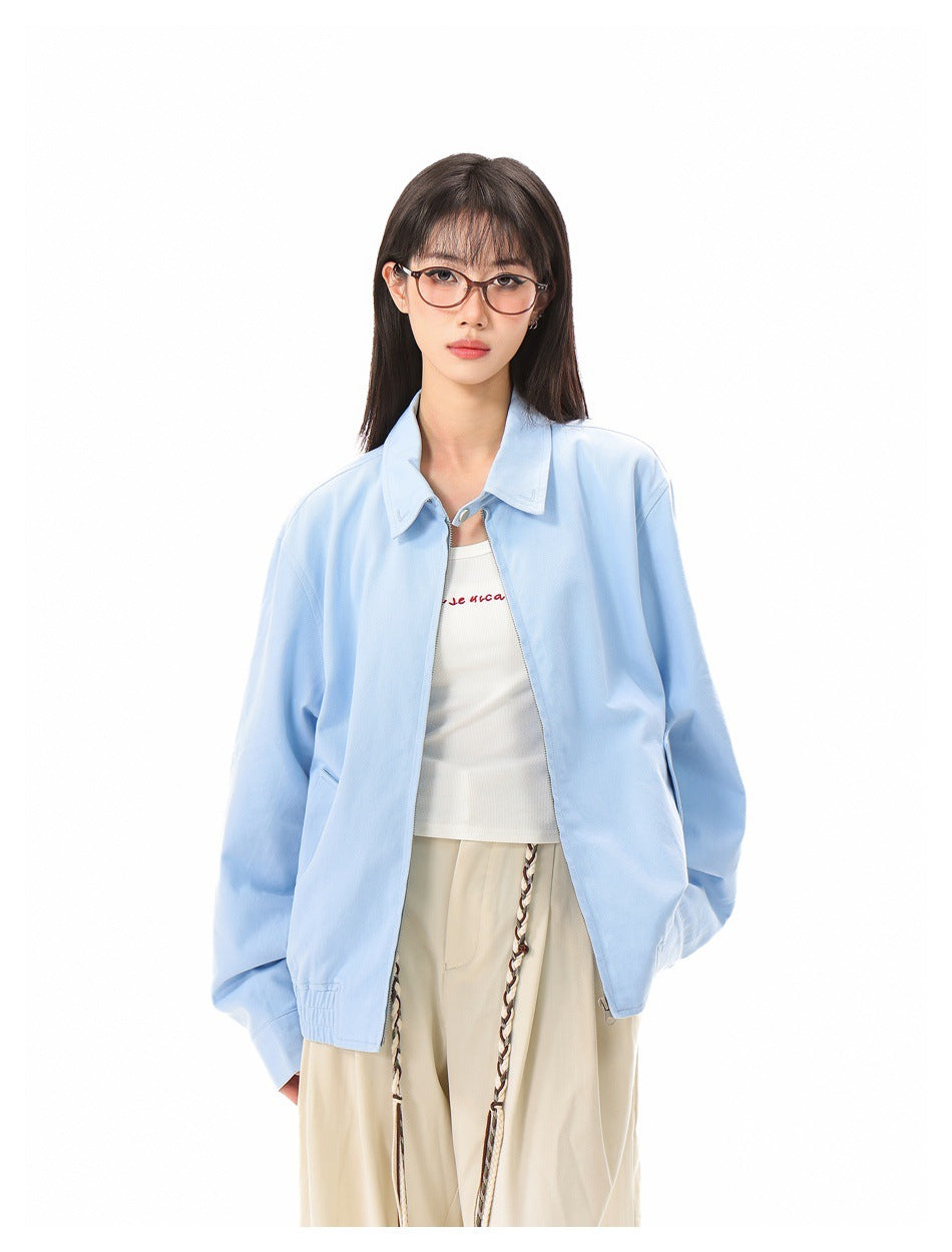 Model wearing an open light blue collared jacket over a white top, showing the front opening and pocket details.