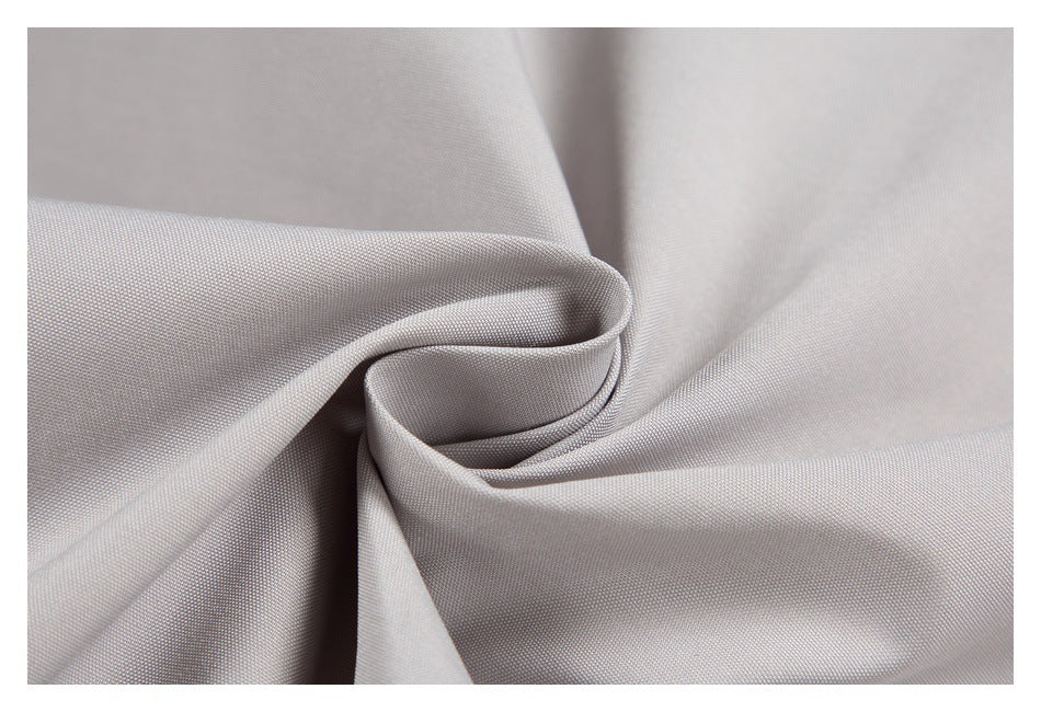 Close-up of light gray jacket fabric gathered into folds.