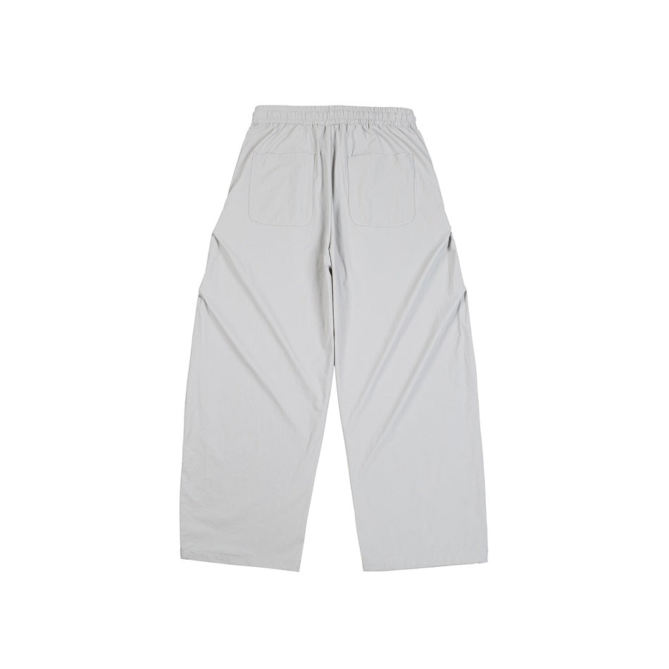Back view of light gray wide-leg trousers with an elastic waistband and two patch pockets.