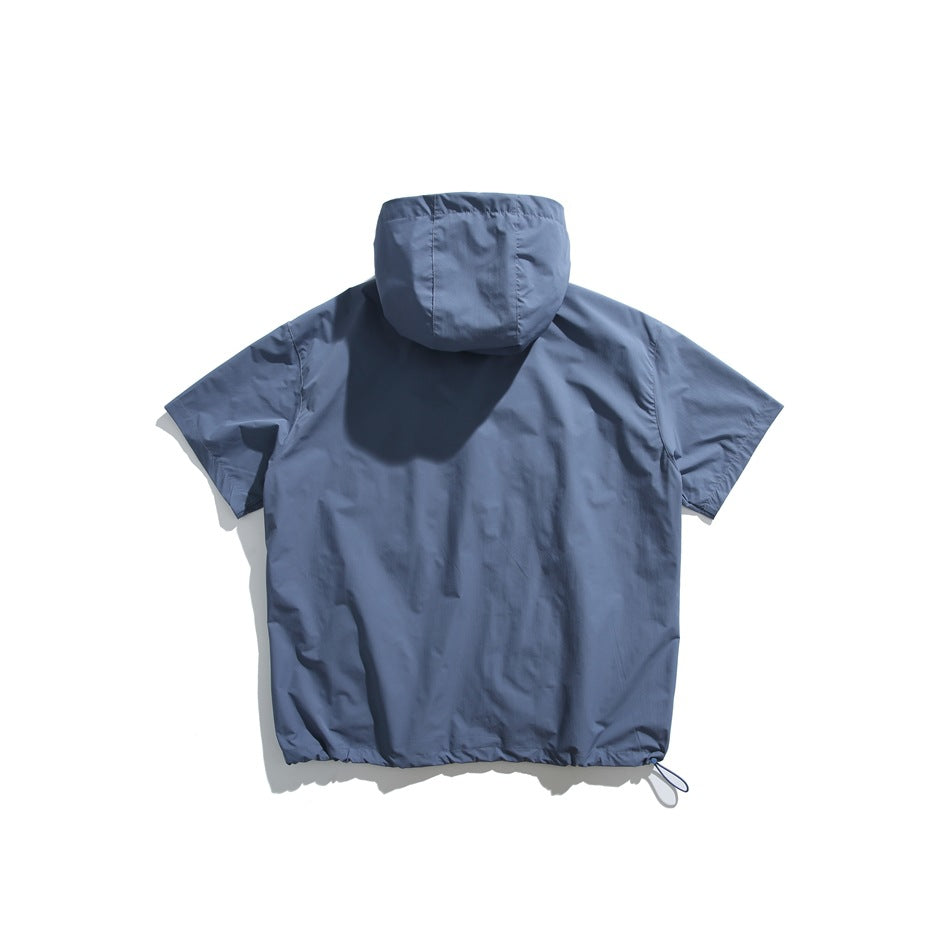 Back view of a slate-blue short-sleeve hooded pullover laid flat, with an adjustable drawcord at the hem.