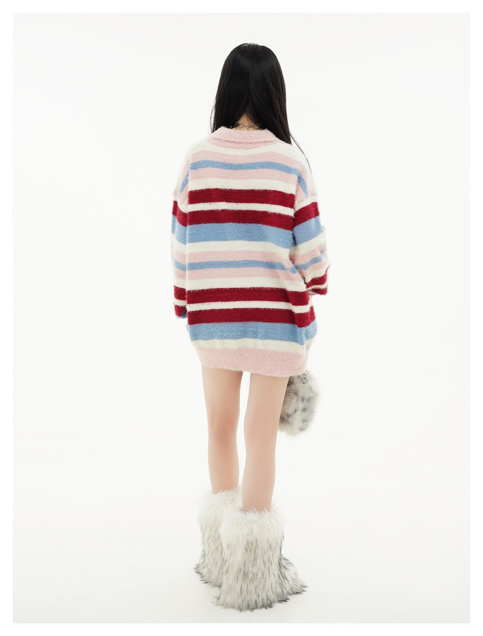 Model wearing the oversized pink, burgundy, white, and blue striped cardigan, back view.