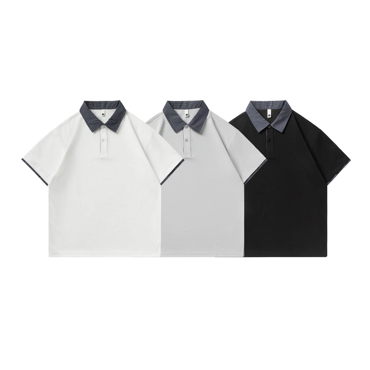 Three short-sleeve polo shirts shown from the front in white, light gray, and black, each with checked collar trim.