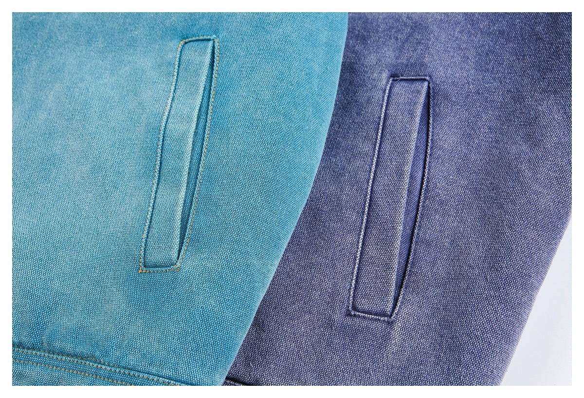 Close-up of teal and indigo jacket sides, each showing a vertical welt pocket.