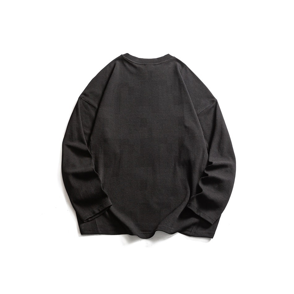 Back view of a dark charcoal long-sleeve knit pullover laid flat on a white background.